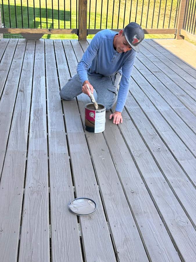 Crew member staining deck boards